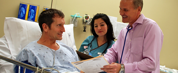 James Hakert, M.D. and nurse with patient